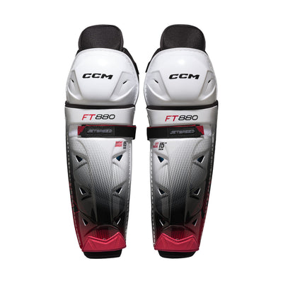 Jambières de hockey CCM JETSPEED FT880 pour adultes, blanc et noir, vue de face de la paire avec coques de genou