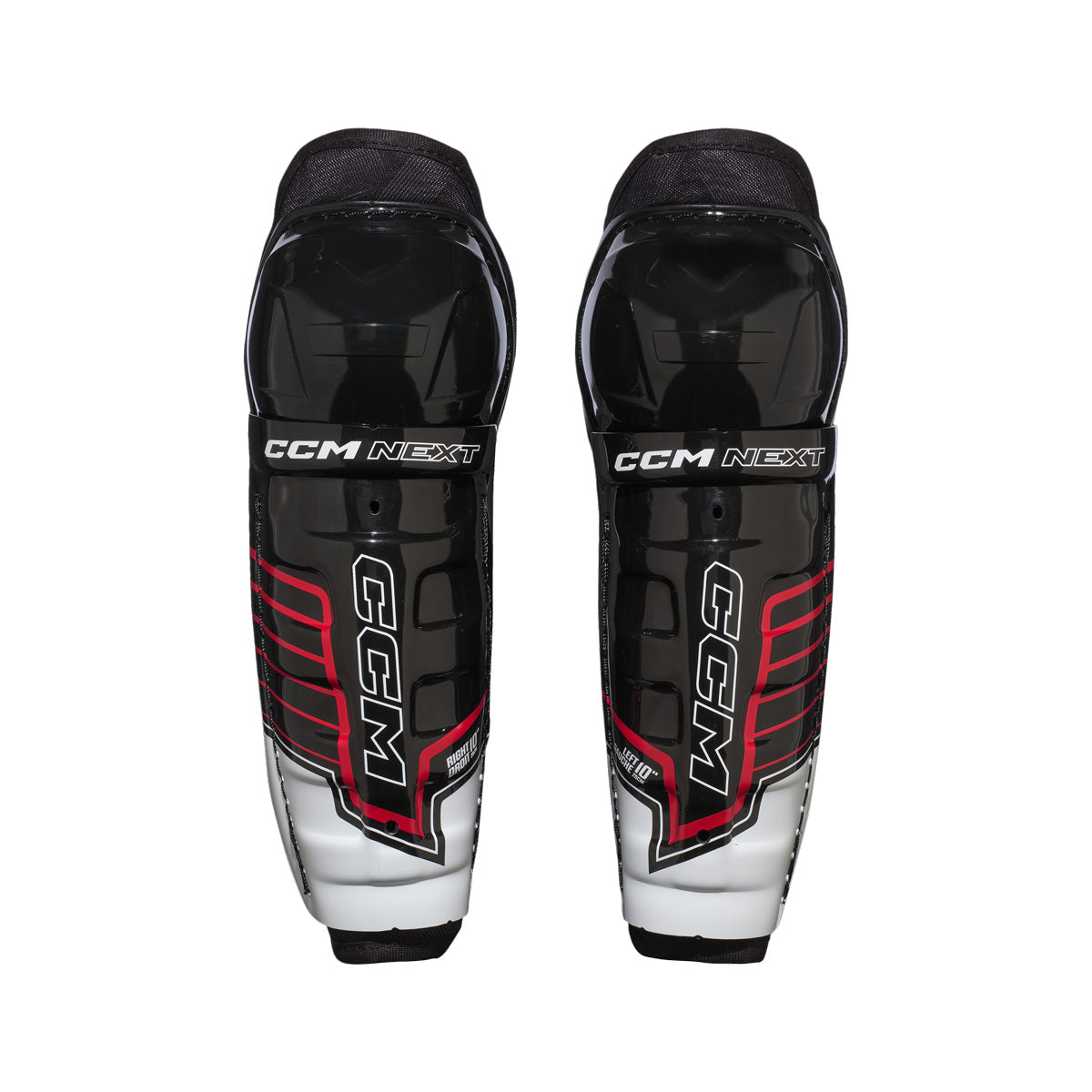 Jambières de hockey CCM Next 26 pour petits enfants, vue de face de la paire avec le logo CCM NEXT sur la coque