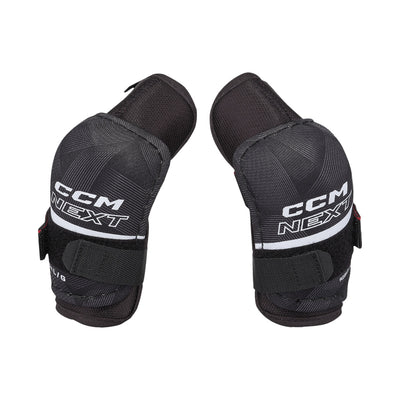 Coudières de hockey CCM Next 26 pour petits enfants, noir, paire avec logo CCM NEXT, bande blanche et courroies